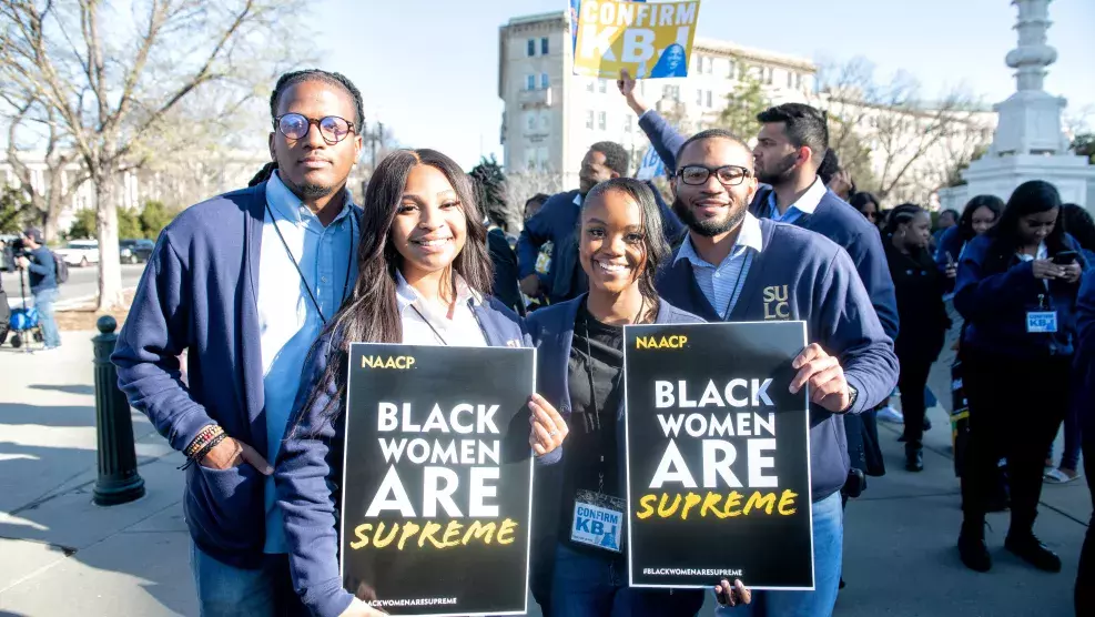 College Students Holding Black Women are Supreme Sign
