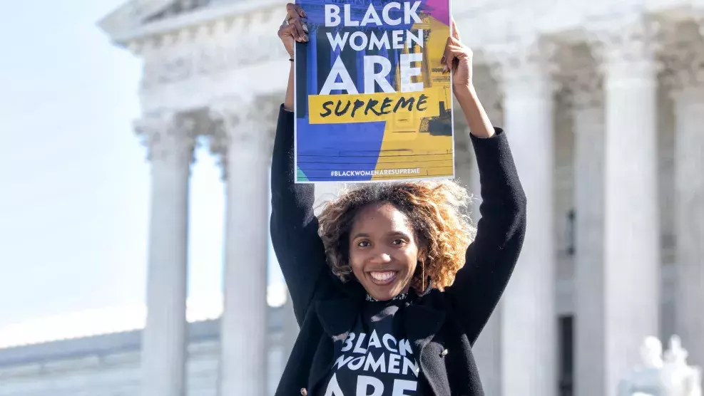 Woman Holding Black Women are Supreme Sign with Shirt
