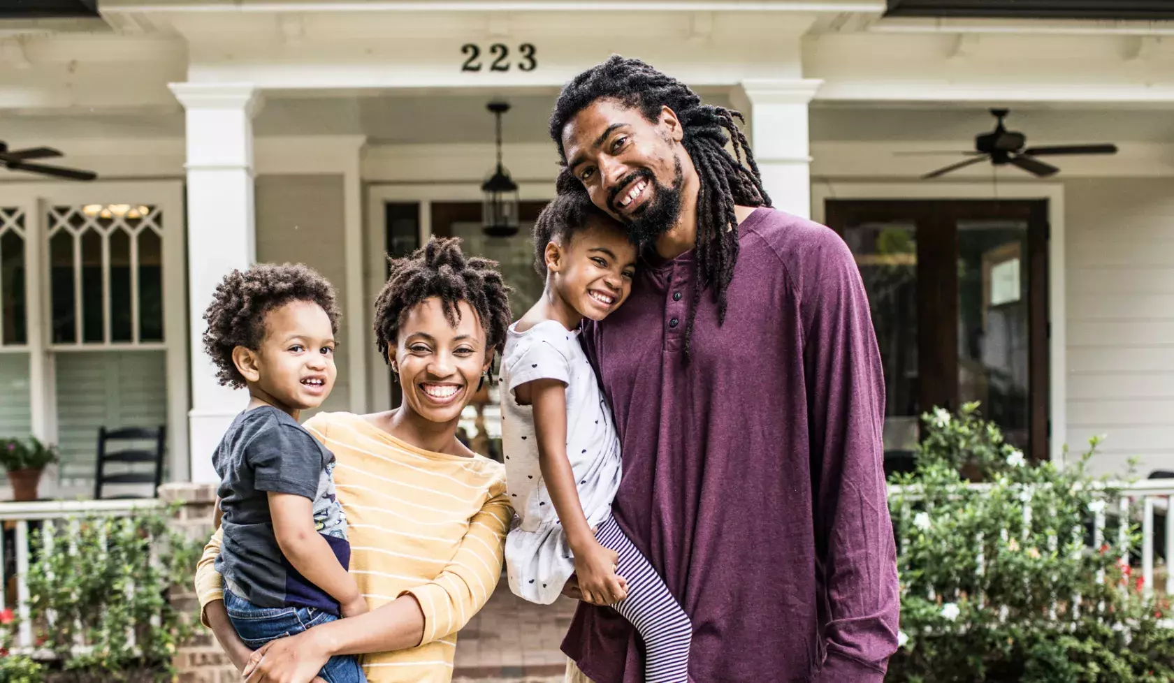 Happy Black Family outside of house