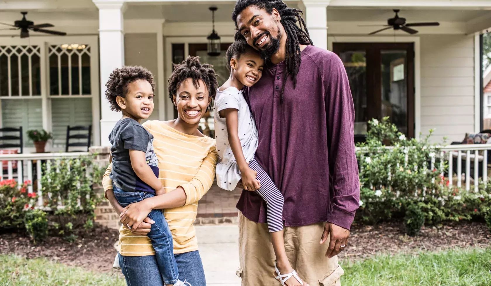 Happy Black Family in front of house