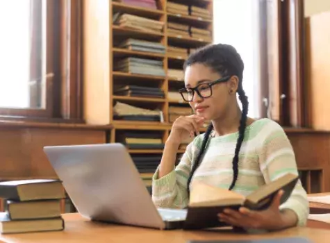 Young Black Student Working on Laptop and Studying Books