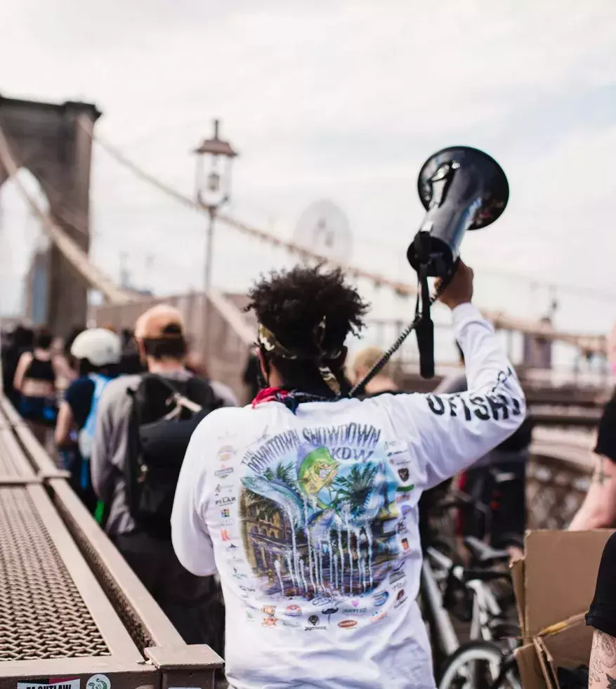 Group marching over Brooklyn Bridge