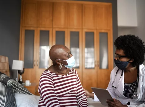 Older Masked Woman at Doctor's Visit