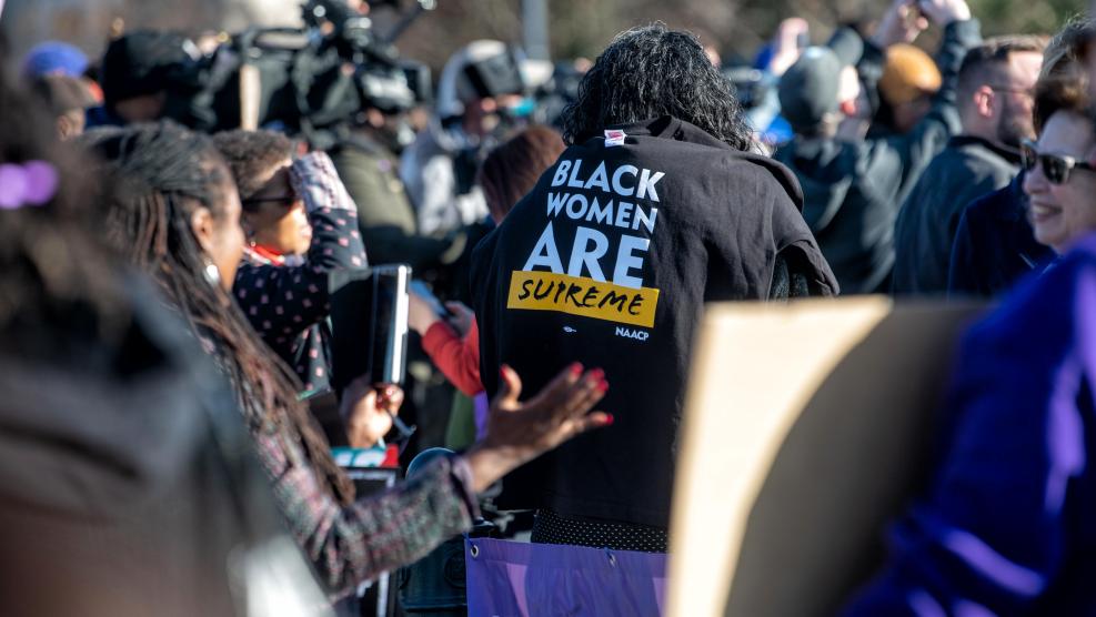 Woman with Black Women are Supreme Shirt on Back