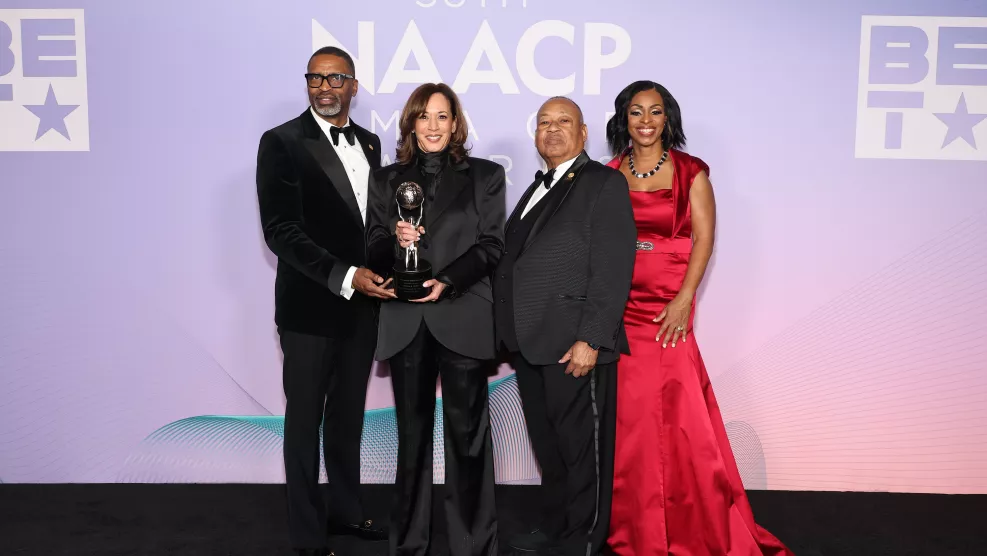  NAACP President and CEO Derrick Johnson, former Vice President Kamala Harris, NAACP Board Chairman Leon Russell, and NAACP Board Vice Chair Karen Boykins-Towns pose for a photo.