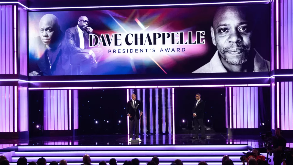 Comedian Dave Chappelle onstage with NAACP President and CEO Derrick Johnson as he accepts the President’s Award during the 56th NAACP Image Awards at the Pasadena Civic Auditorium.