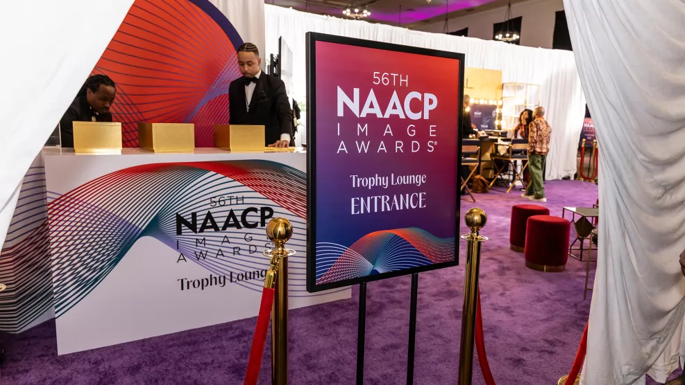 A sign reads NAACP Image Awards Trophy Lounge.