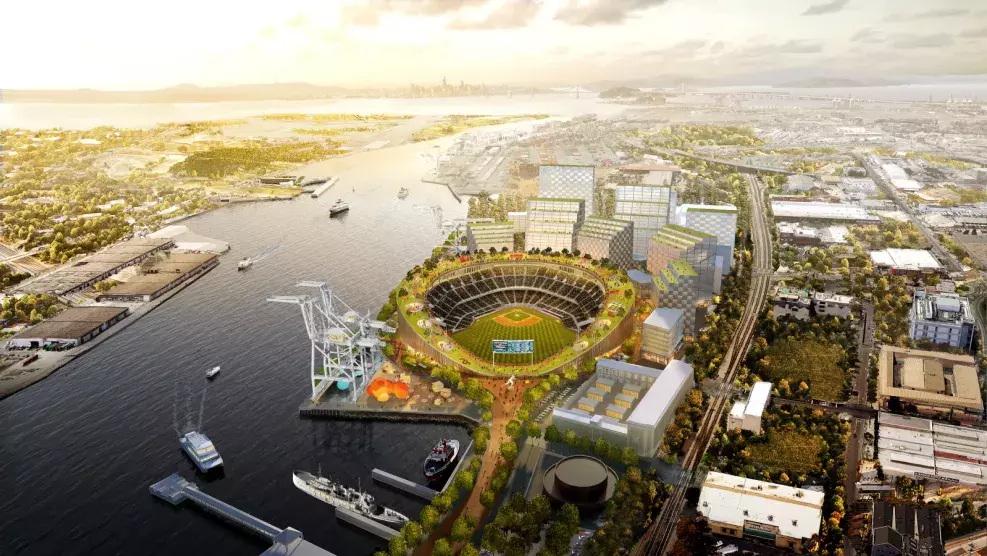 Bird's eye view of a digital rendering of a baseball stadium within a city landscape next to a waterfront.