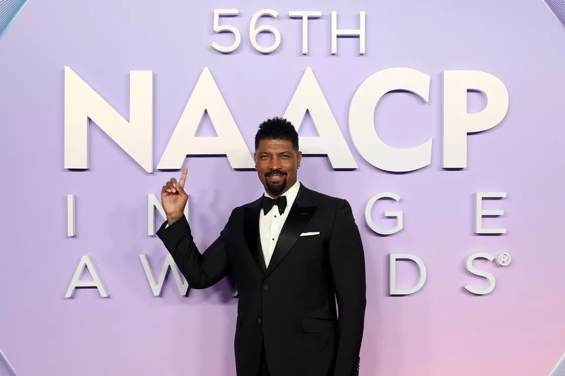 Comedian Deon Cole poses on the red carpet at the 56th NAACP Image Awards.