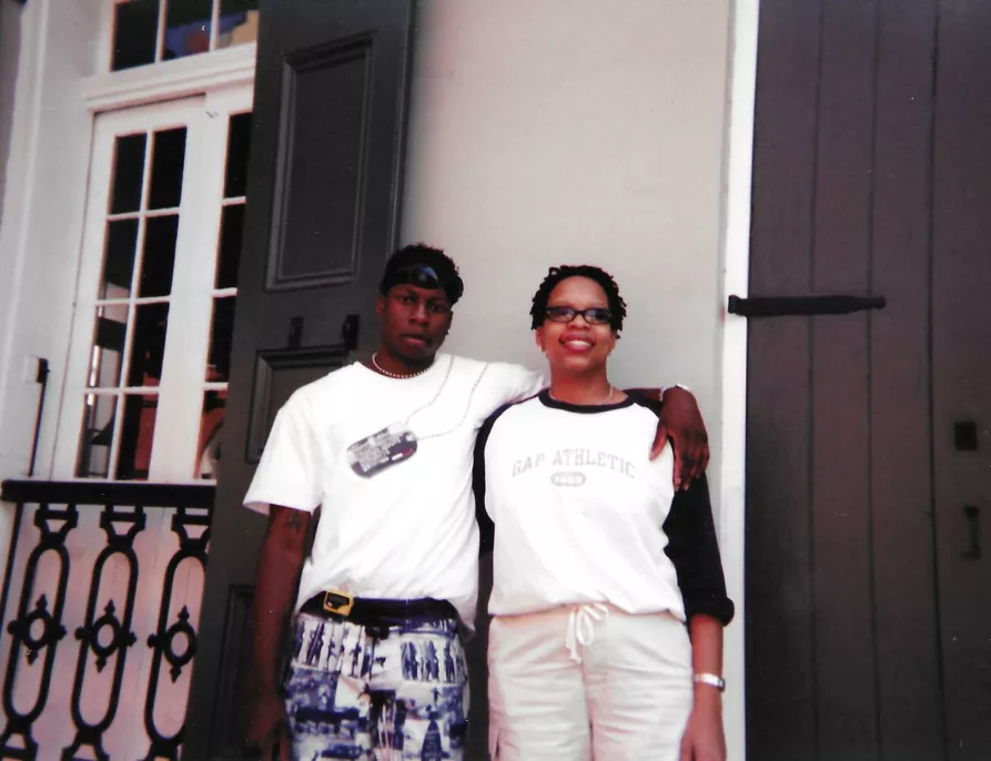 Airis Freeman and her brother pose for a photo in front of a beige building in the French Quarter of New Orleans.
