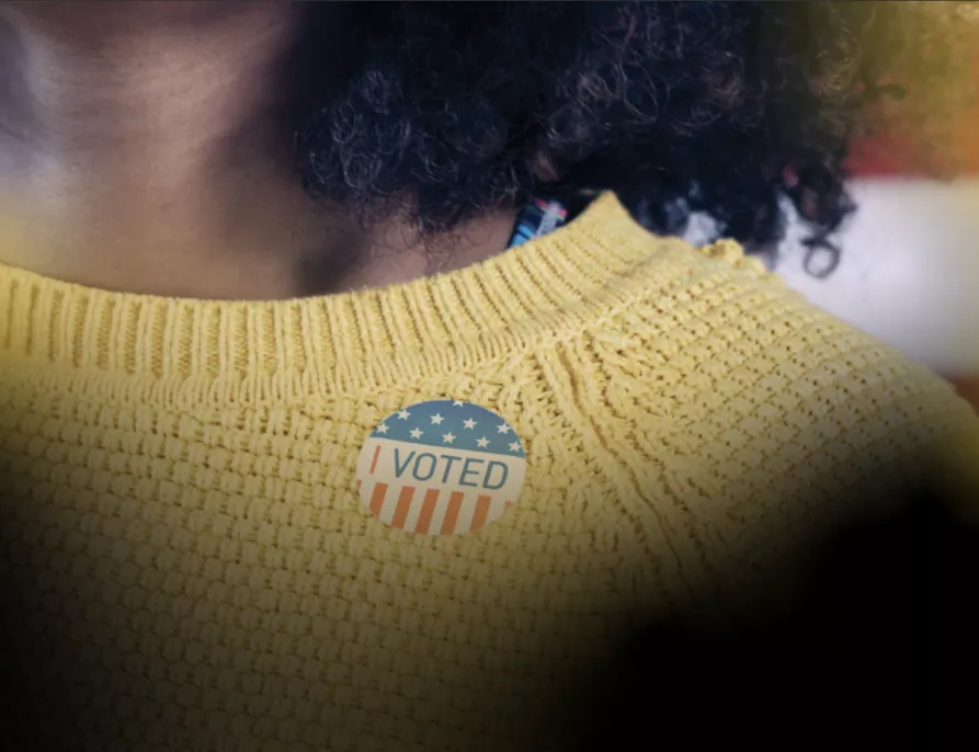 Black Voter Day Hero - Black woman wearing I Voted Sticker