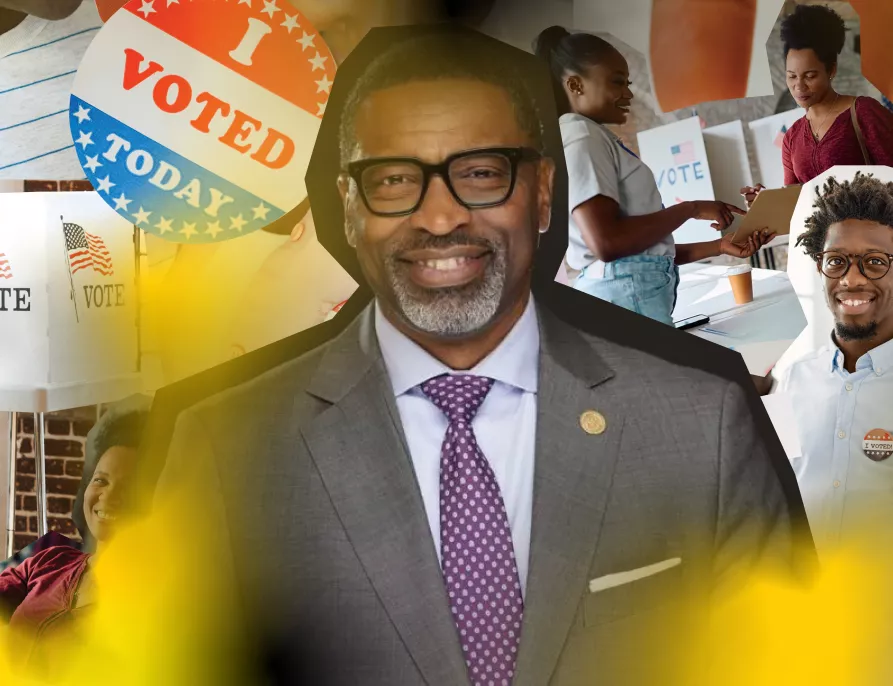 Headshot of Derrick Johnson with voting paraphernalia in the background