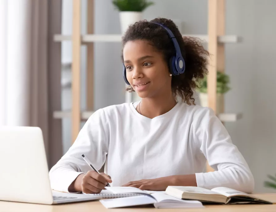 Young Black Girl with Headset Taking an Online Class