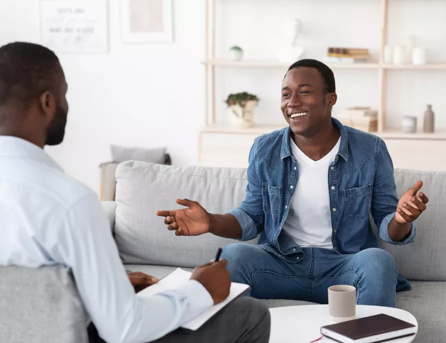 Two Black Men in Conversation and Taking Notes - Inside