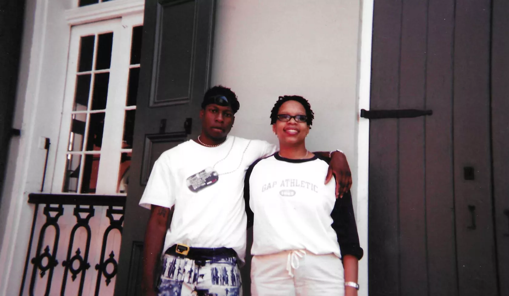 Airis Freeman and her brother pose for a photo in front of a beige building in the French Quarter of New Orleans.