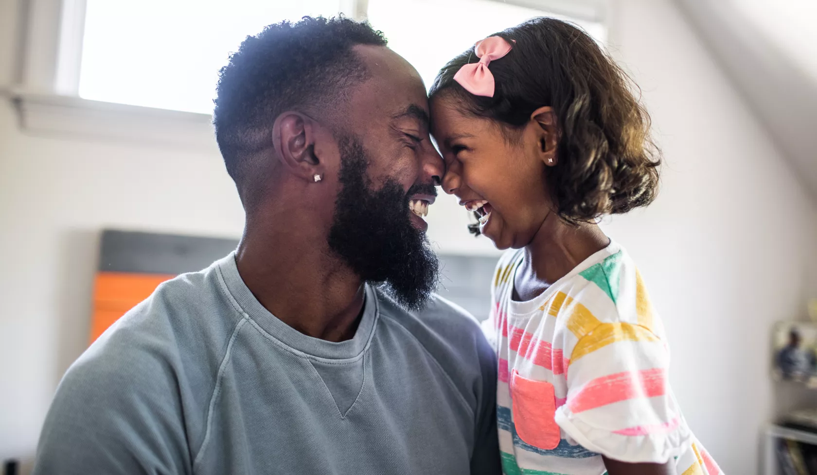 Black Father and Daughter Smiling at each other