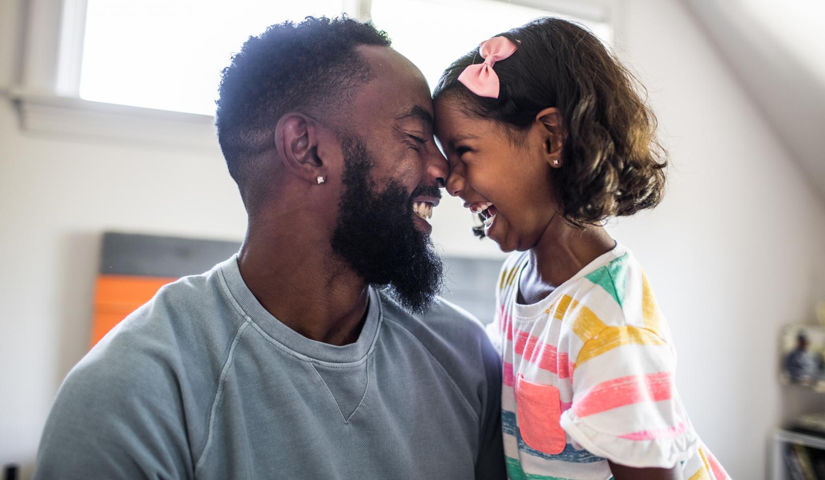Black Father and Daughter Smiling at each other