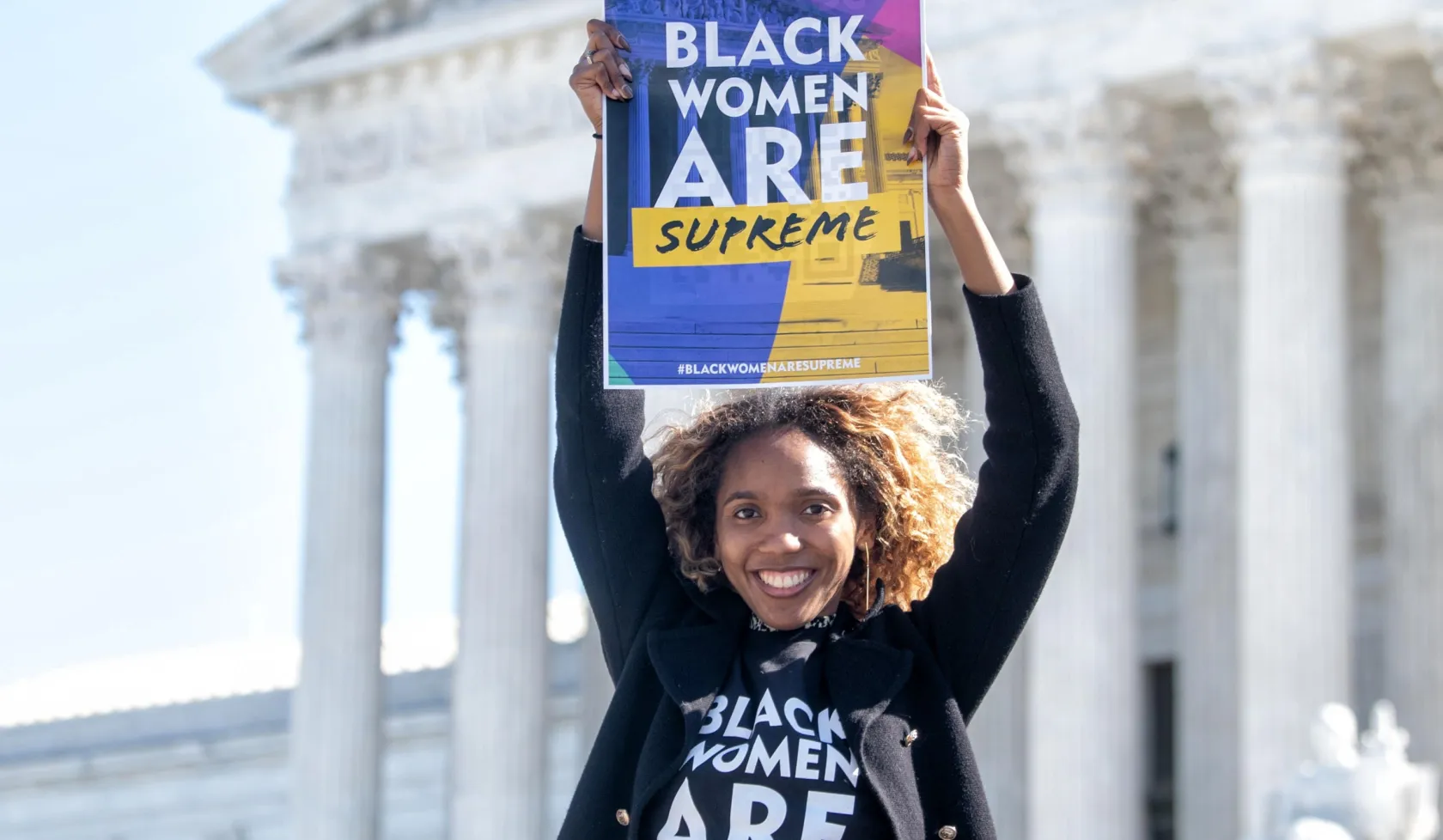 Woman Holding Black Women are Supreme Sign with Shirt
