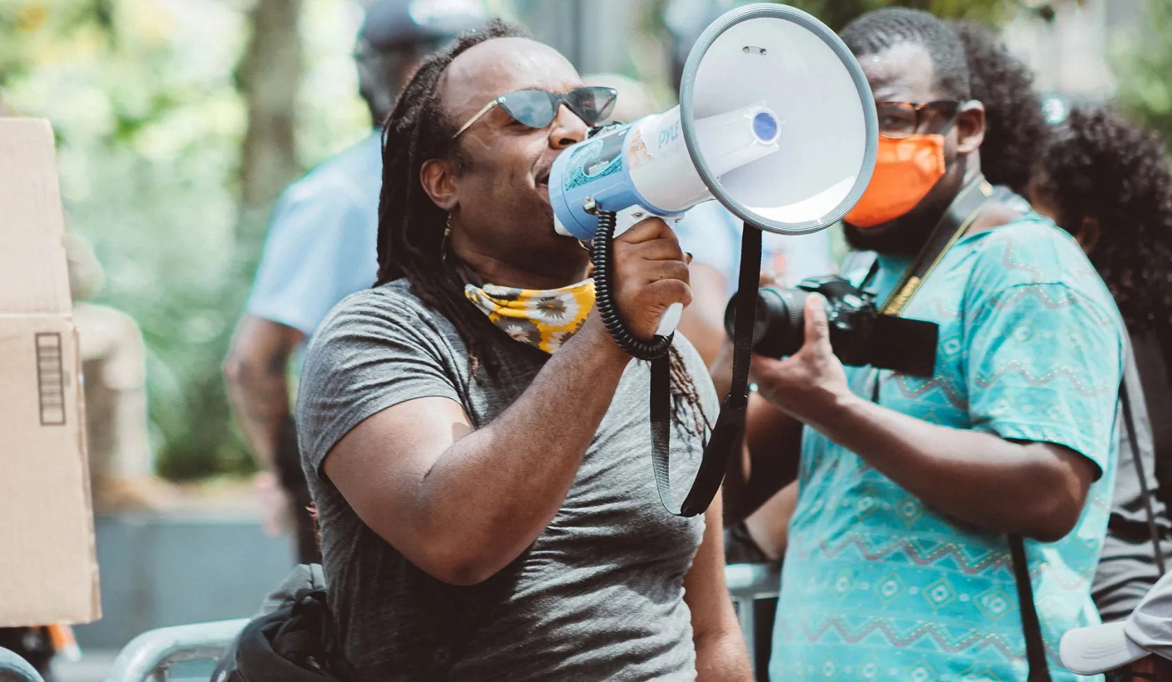 Black Male - Outdoors - Speaking to Group from Bullhorn