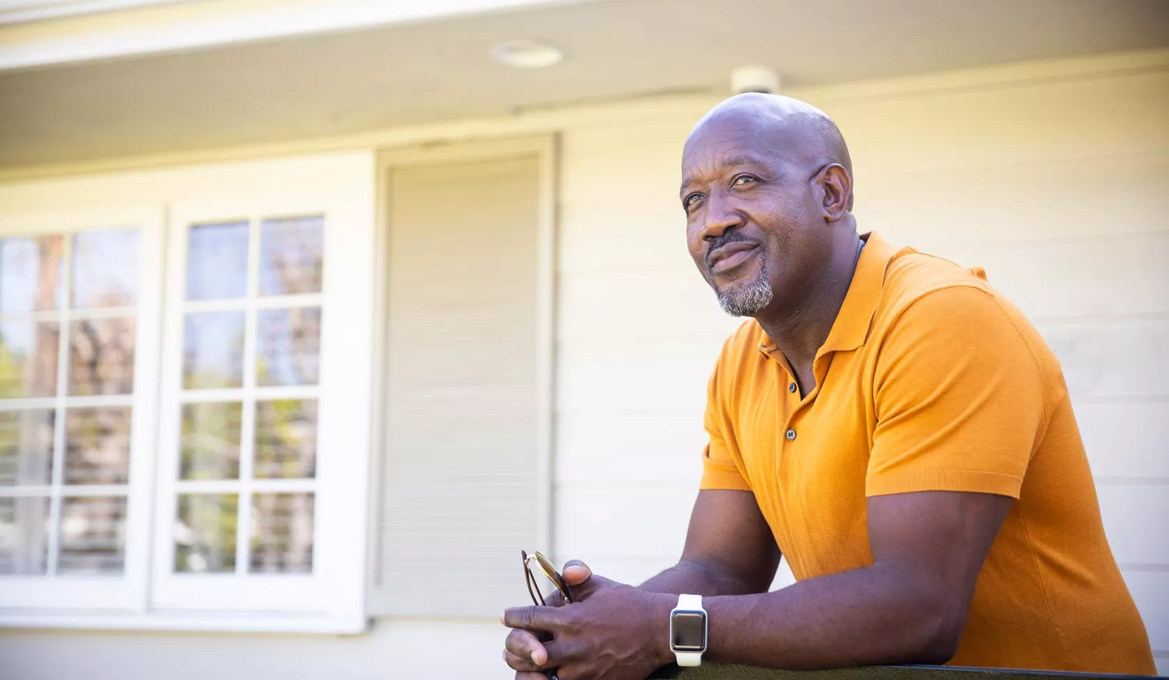 Black Male in Front of House Smiling