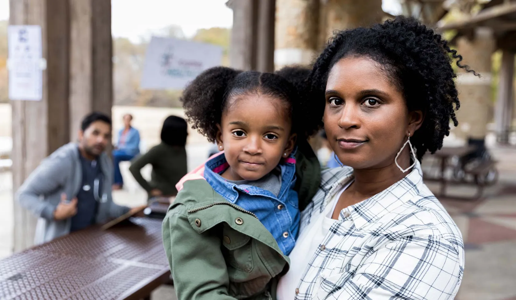 Black Female holding Toddler - Outdoors