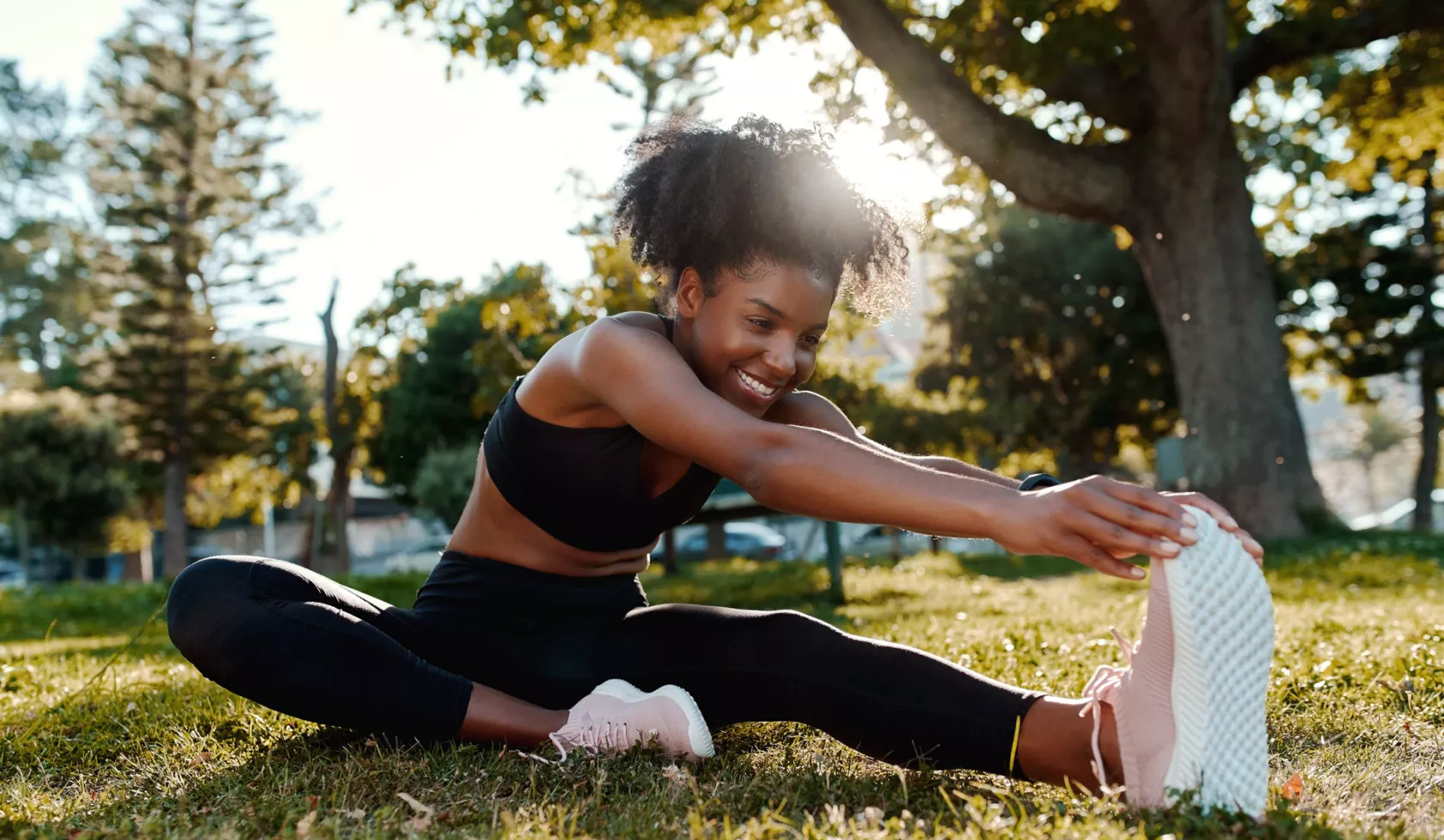 Athletic Young Black Female Stretching Legs Outside