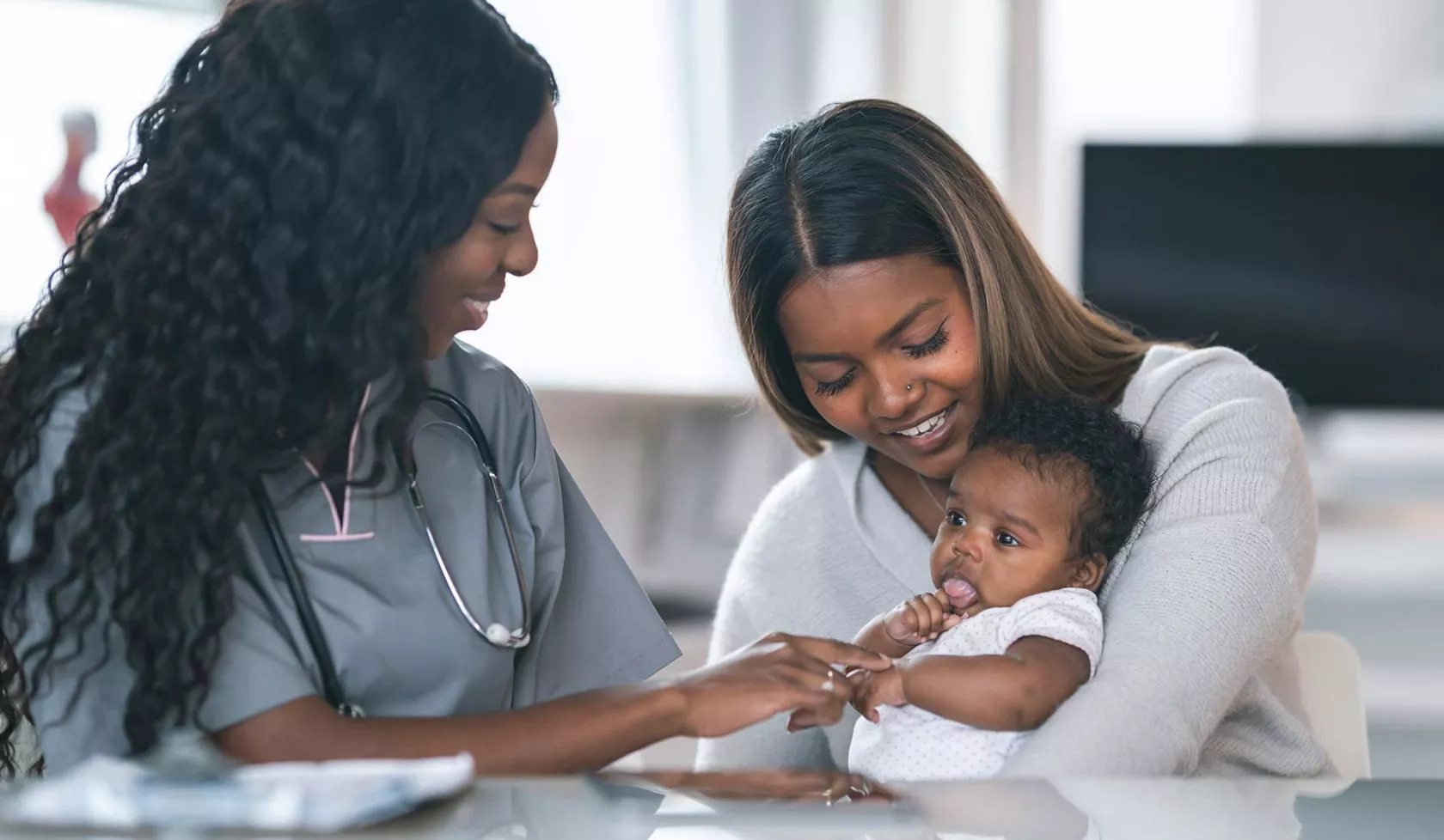 Black Female holding Baby - with Nurse