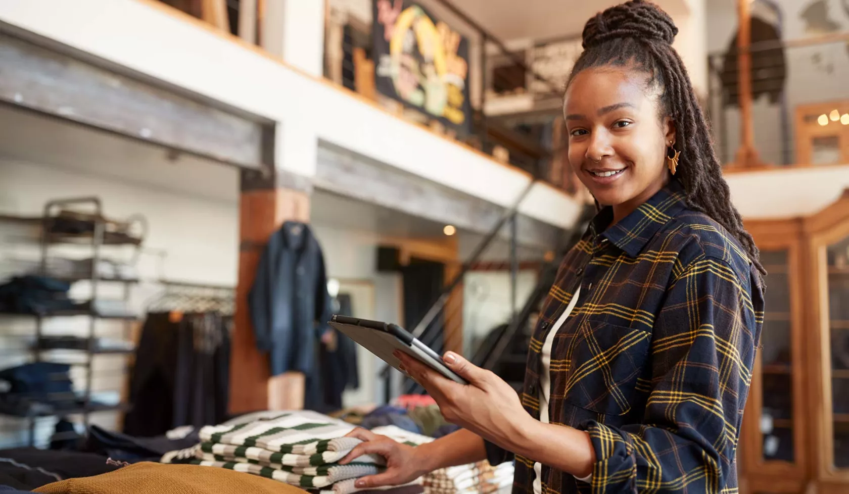 Black Female - Solo - in retail setting - smiling