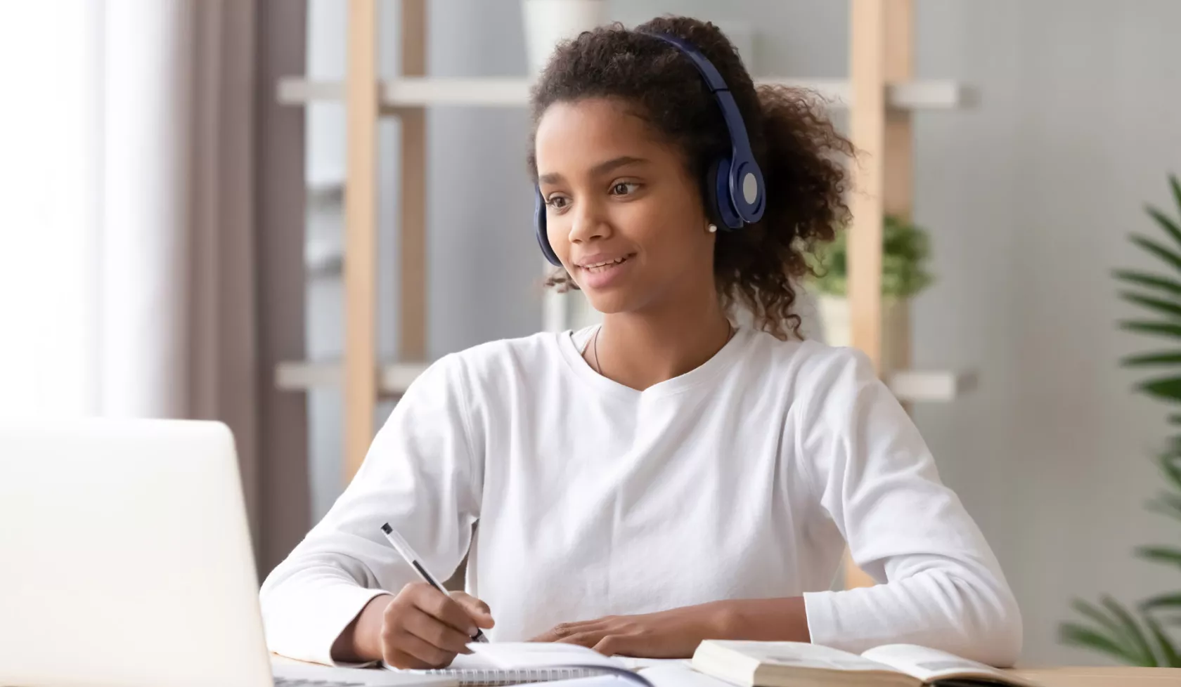 Young Black Girl with Headset Taking an Online Class