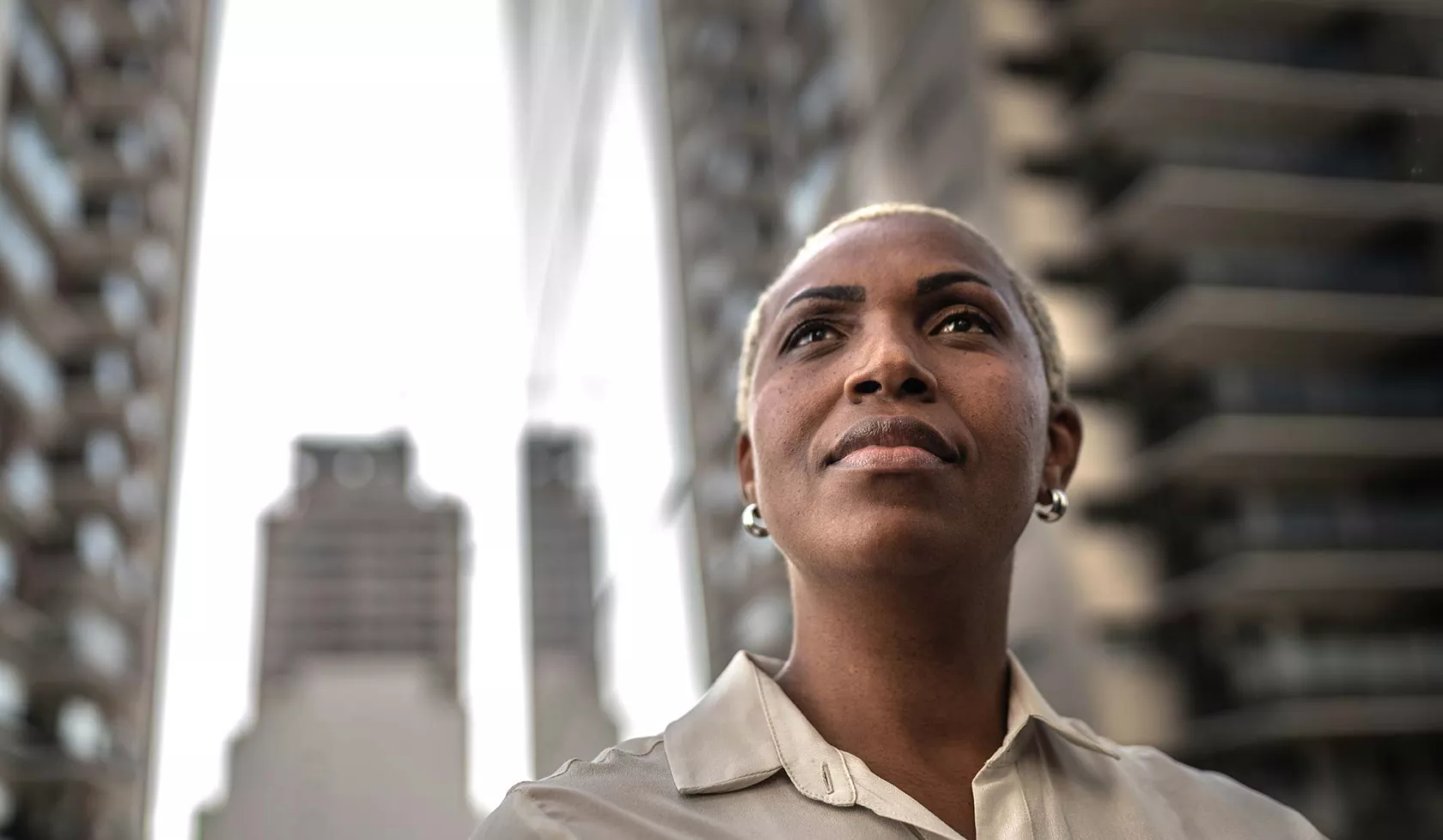 Black Female Looking Up at a Cityscape - Solo