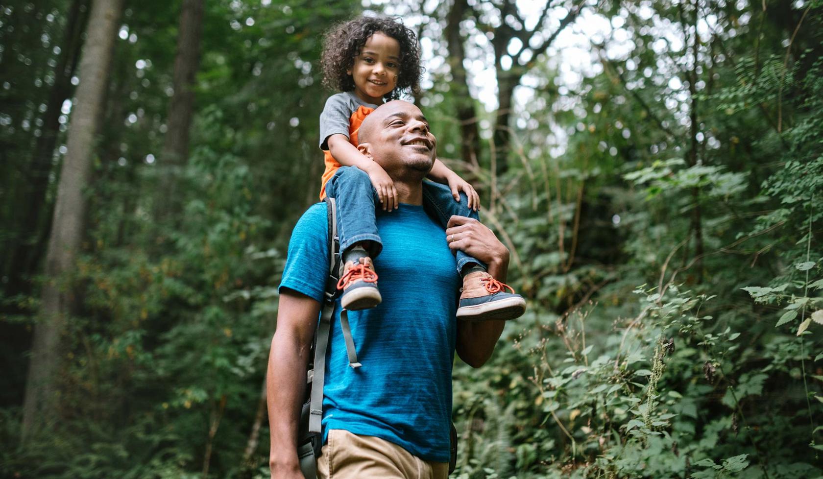 Black Male with Child on His Shoulders - Outside