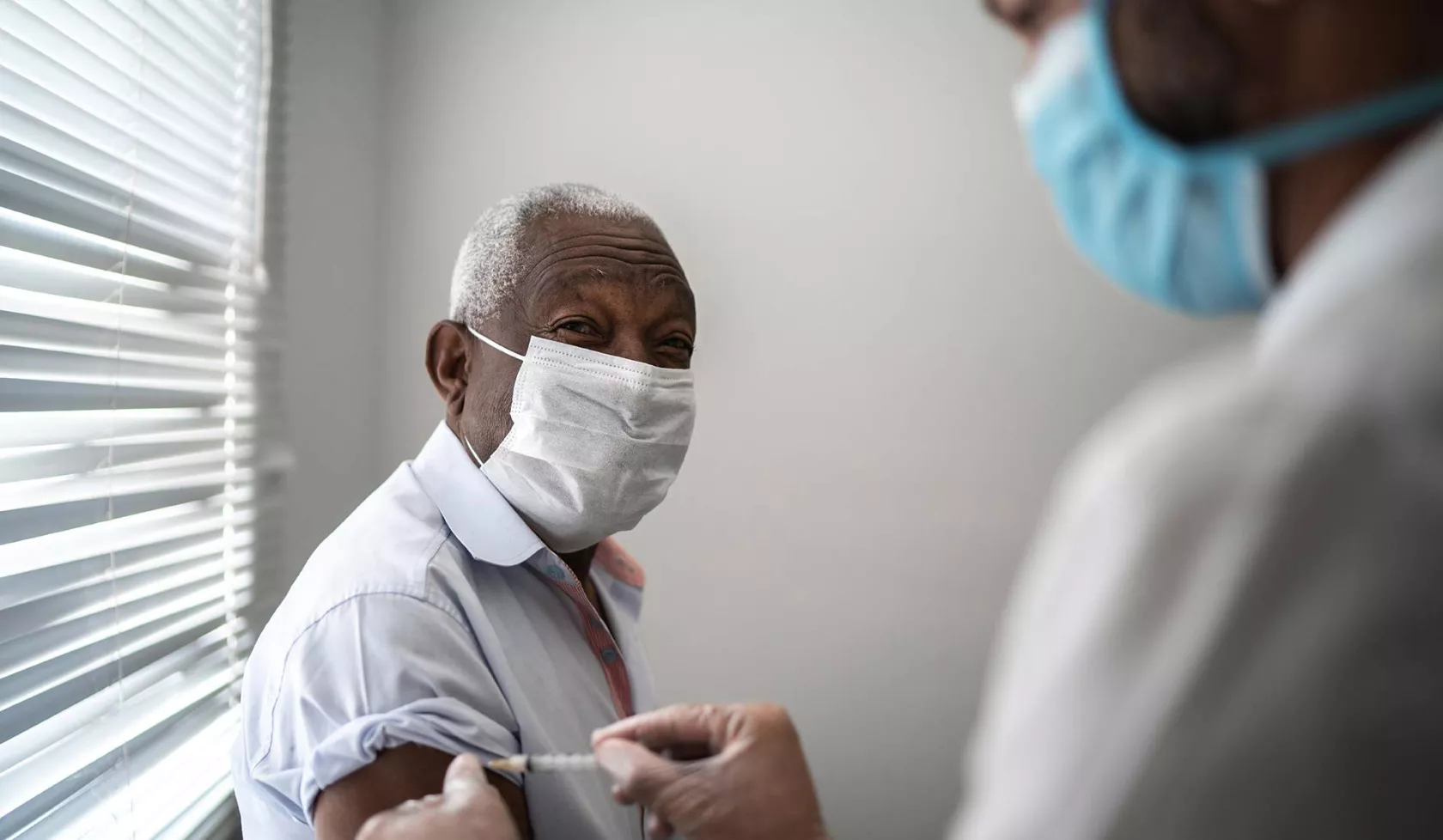 Black Man Getting a Shot From a Doctor