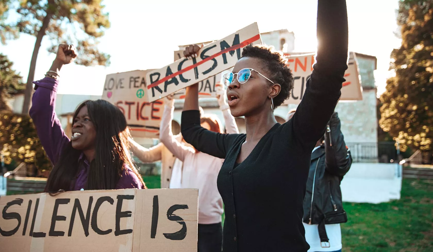 Young Adults Protesting - Holding Signs