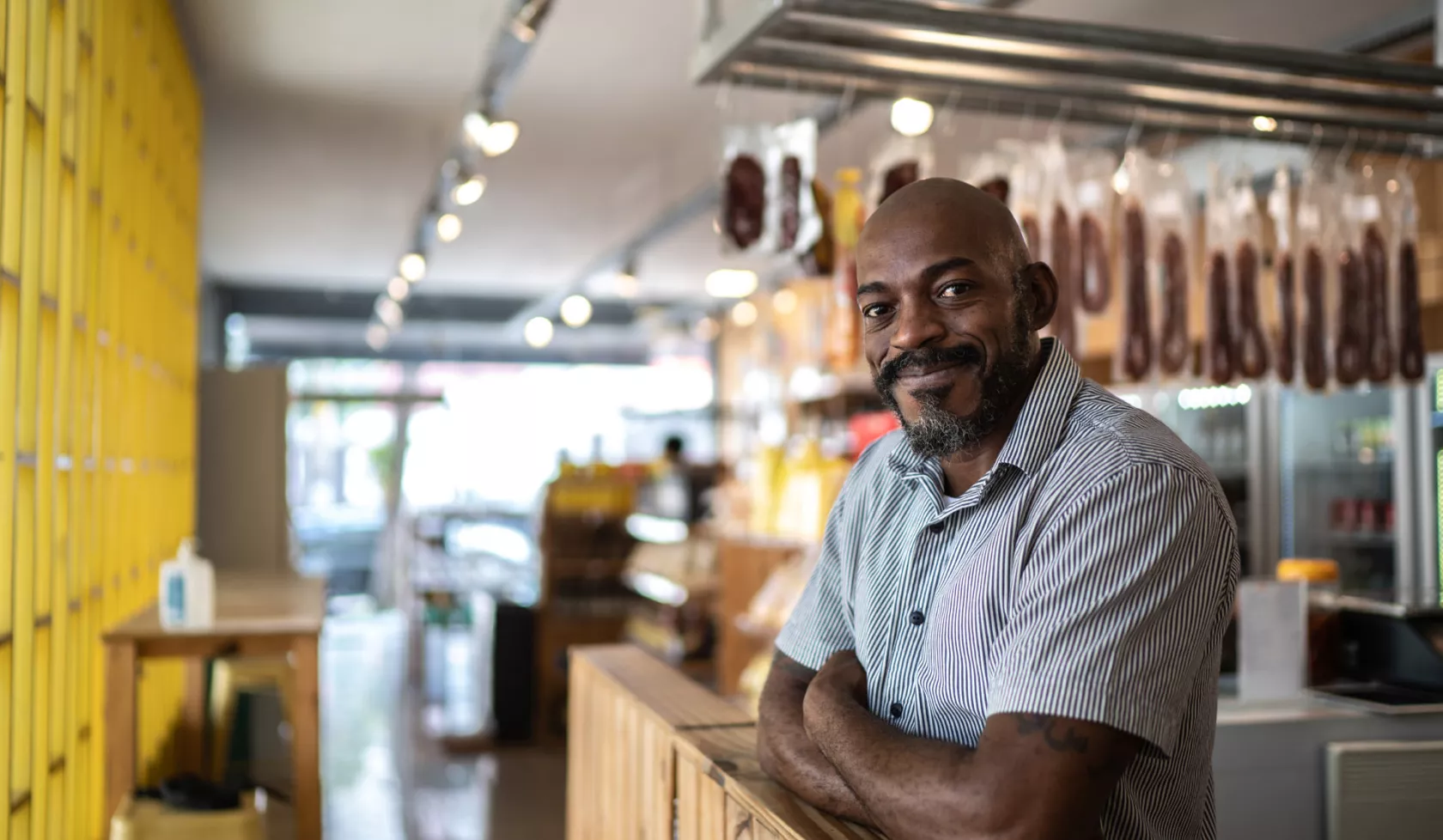 Black Business Owner Smiling at Camera - Inside