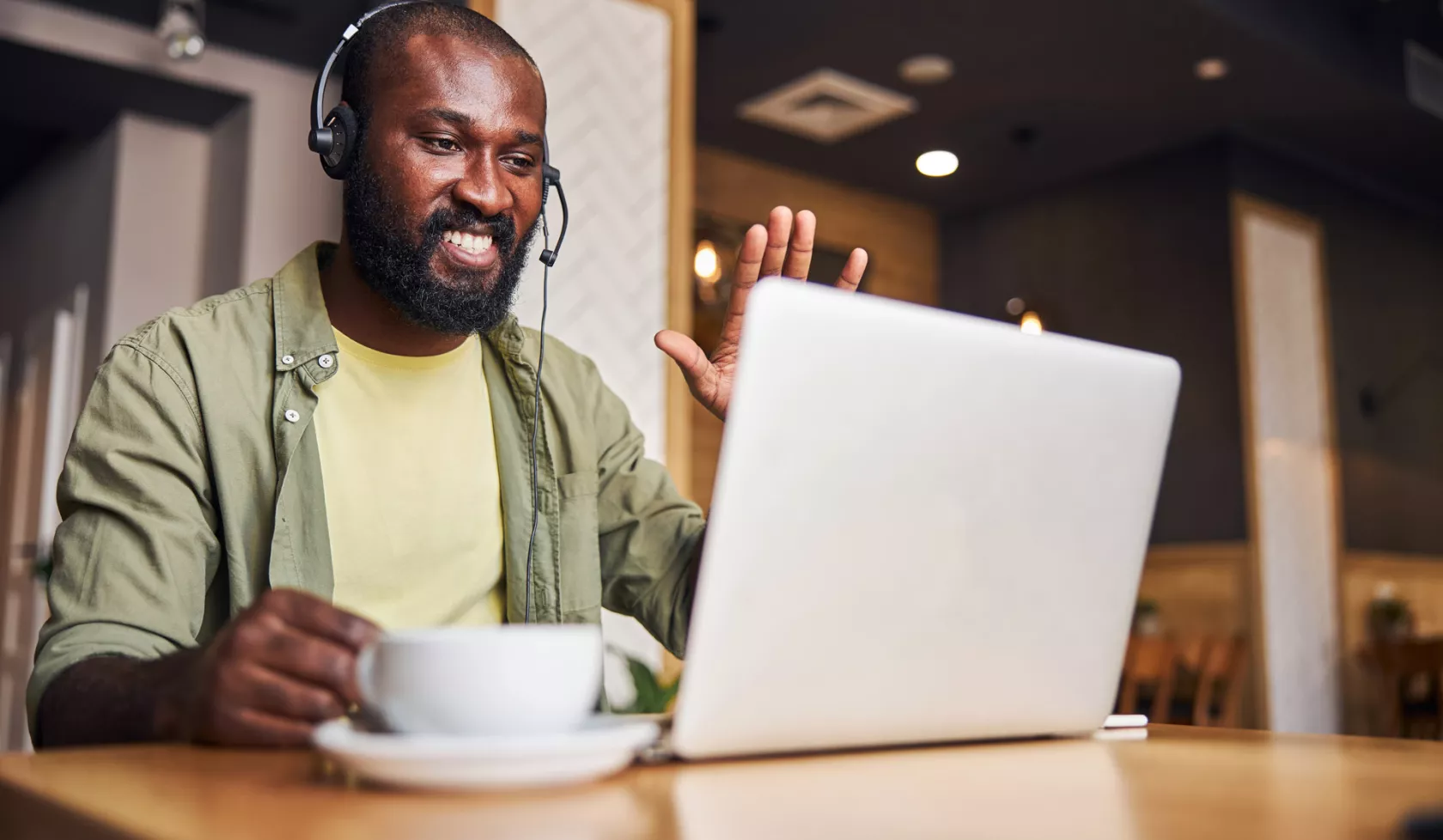 Black Man Wearing Headset on a Laptop Computer Meeting