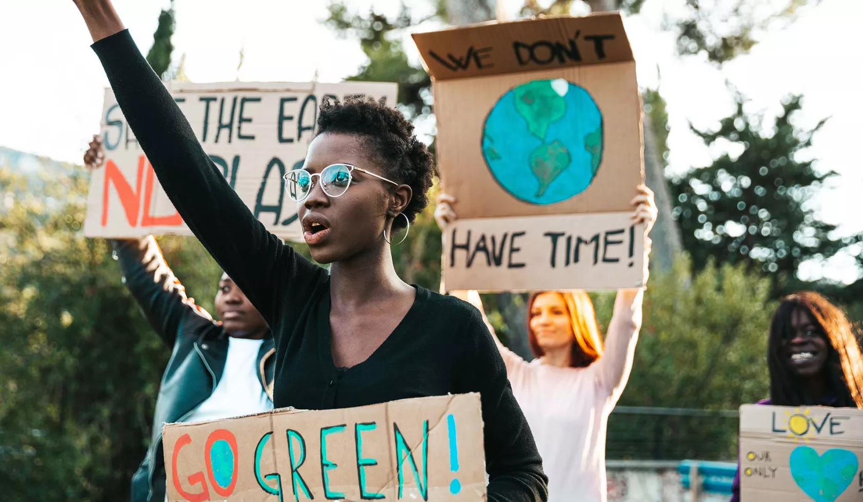 Young Adults Protesting - Holding Signs About the Environment