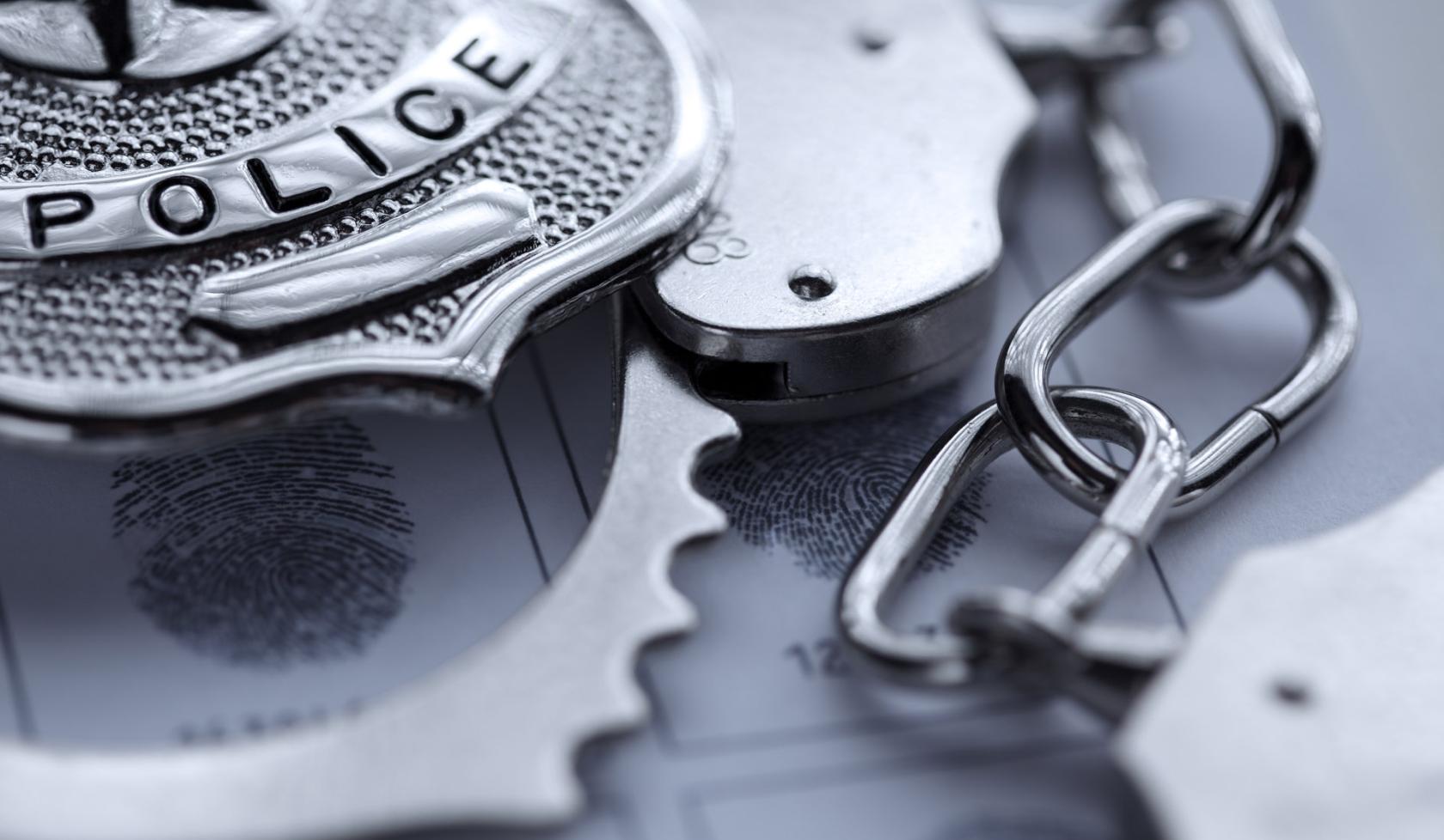 Close-up of Police Badge and Handcuffs