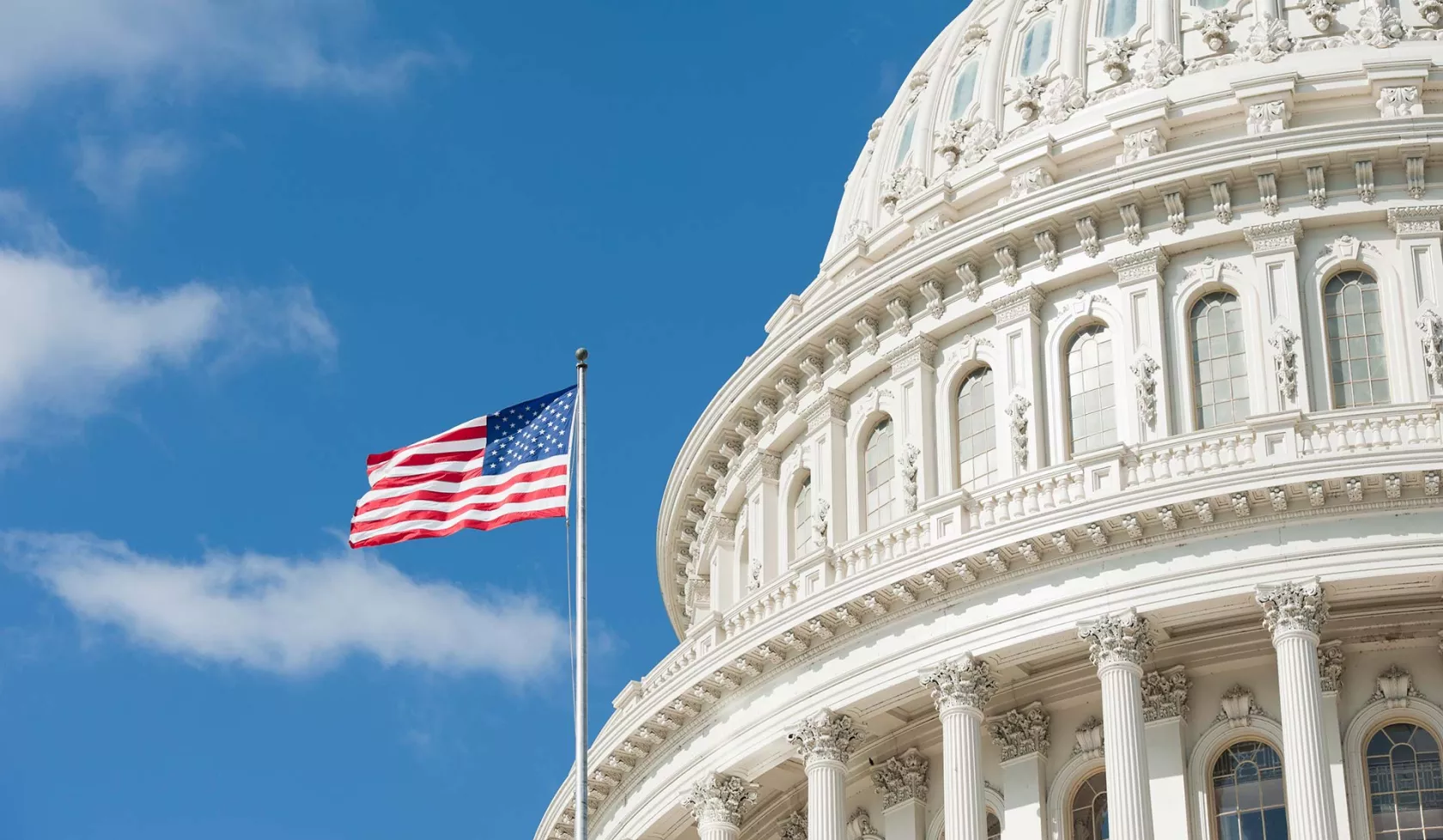 Close-up - The U.S. Capitol Building with American Flag - Daylight