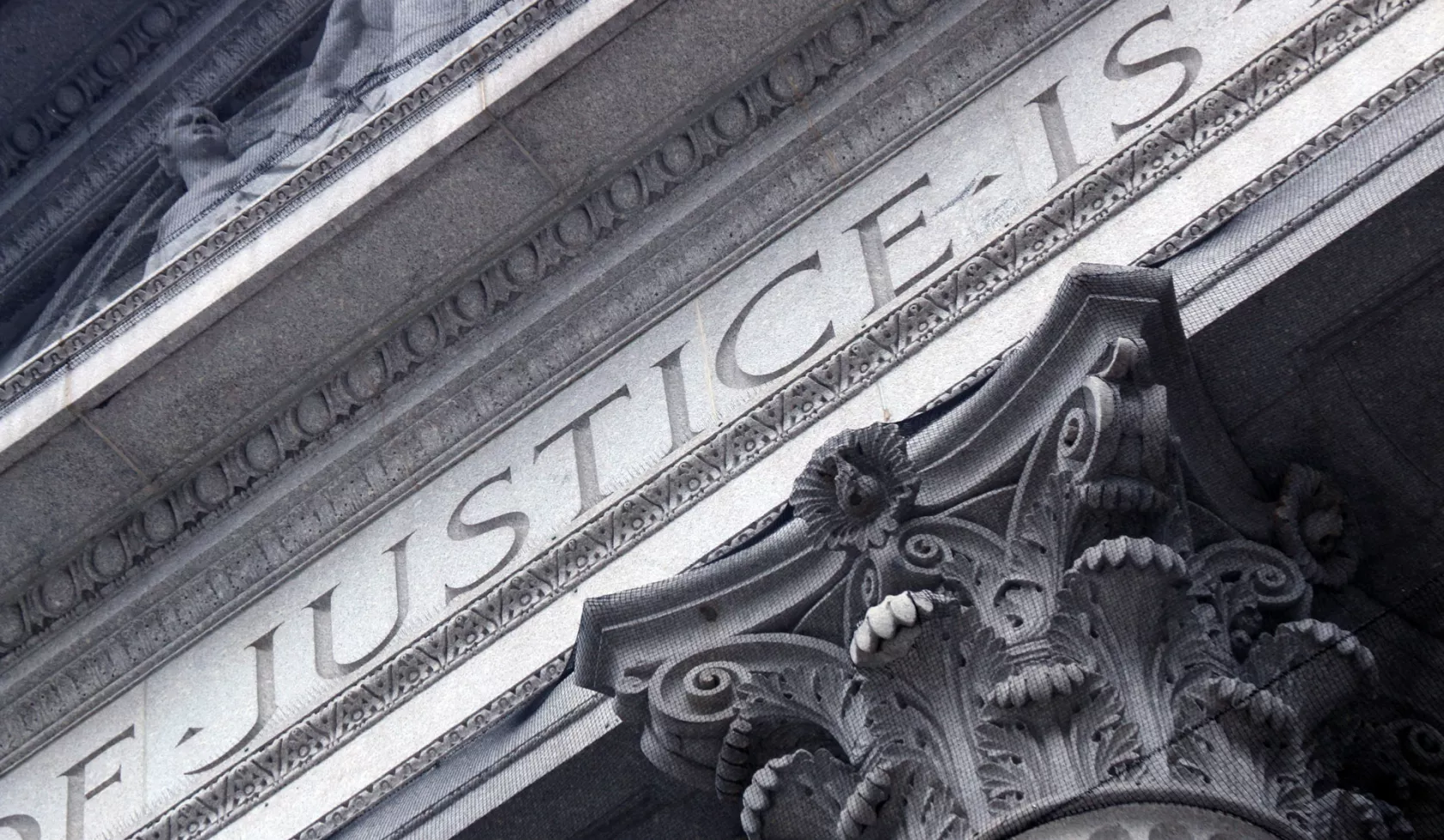 The Word Justice Carved into Architecture of Marble Courthouse