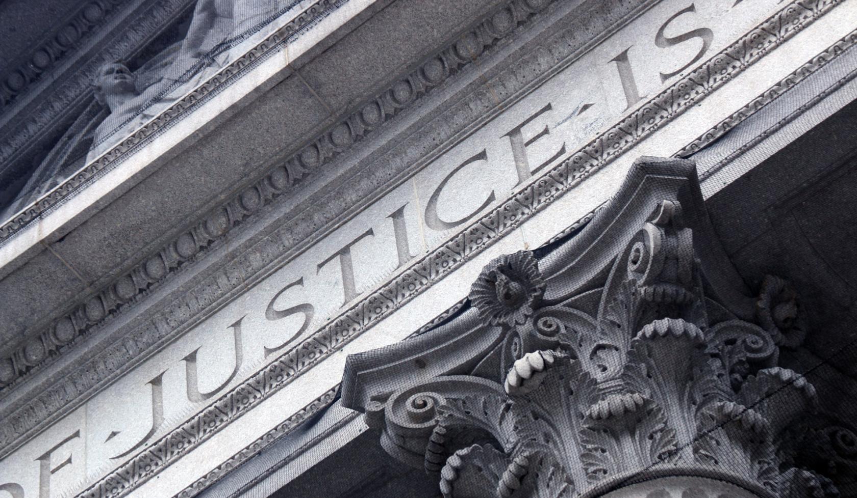 The Word Justice Carved into Architecture of Marble Courthouse