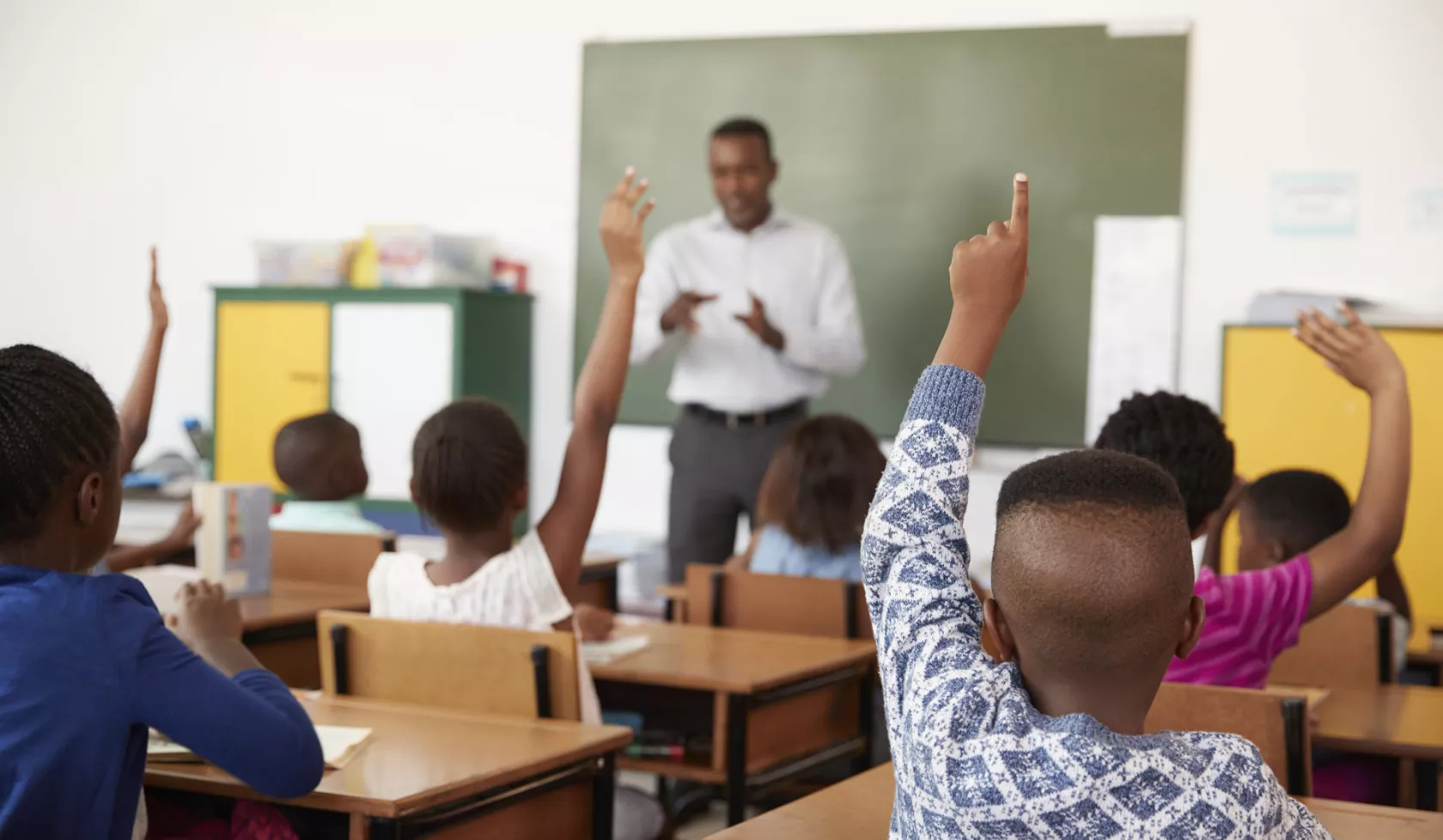 Students Raising Hands in Classroom