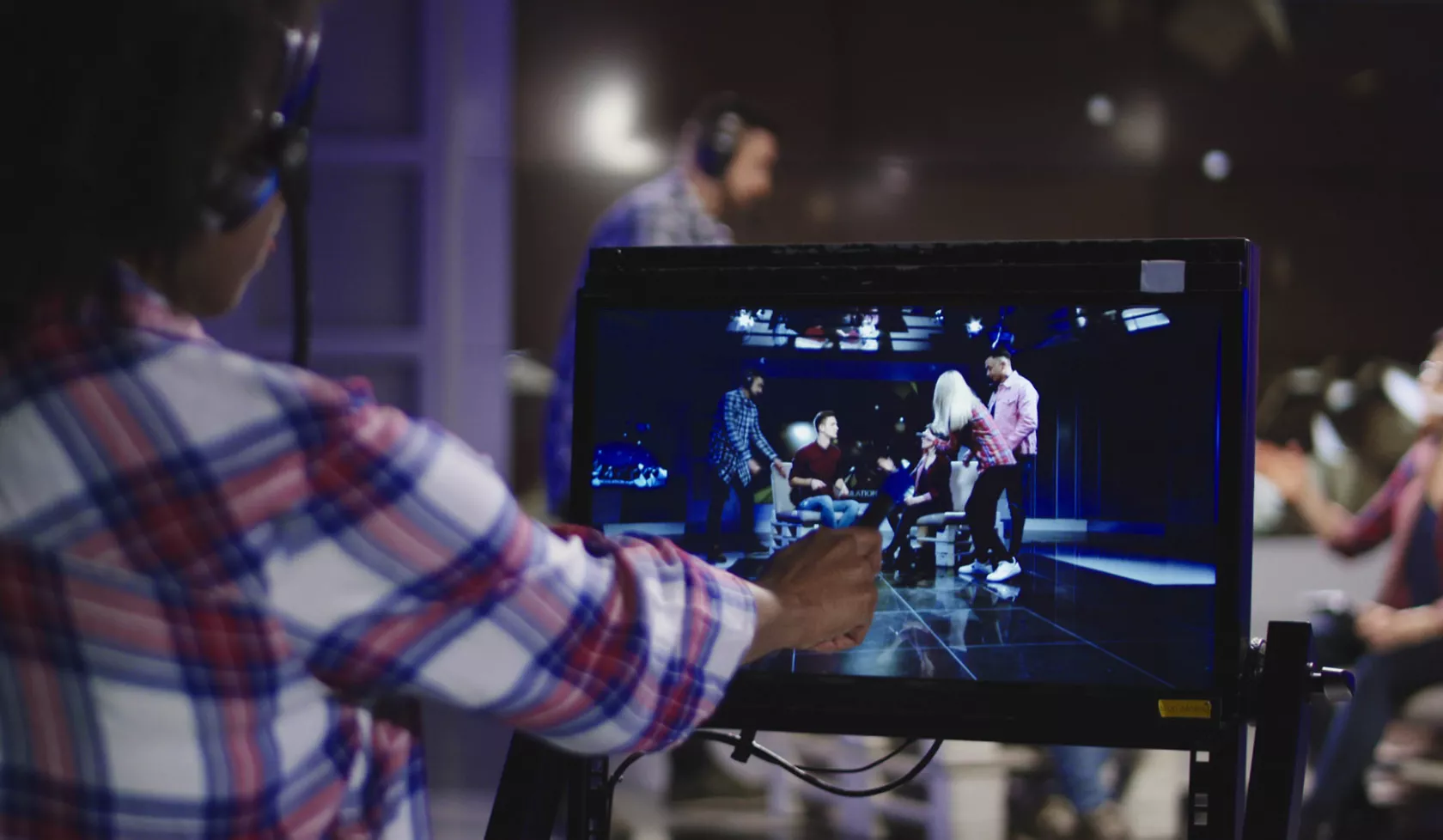 Producer Examining Monitor During Stage Performance Filming