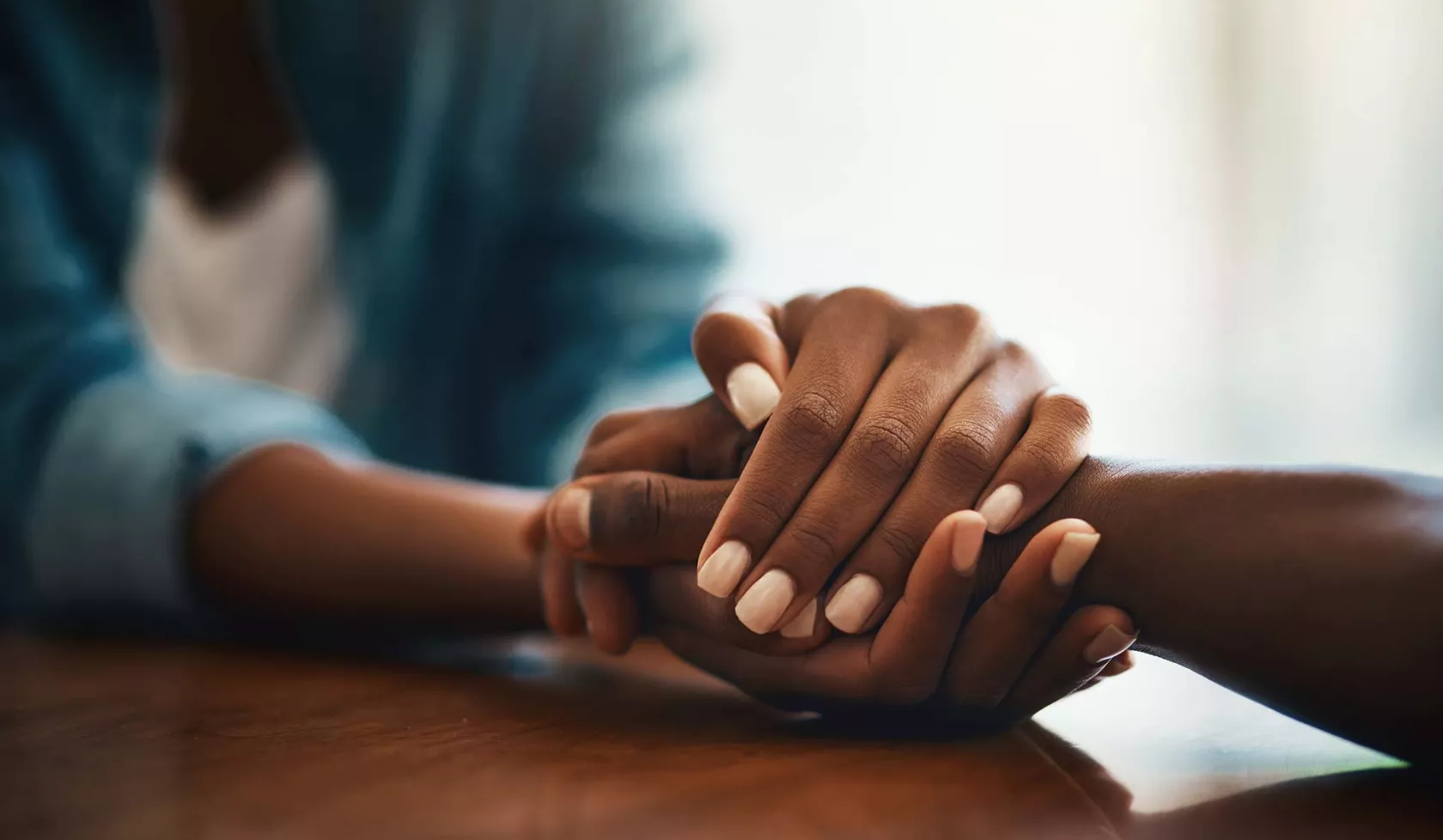 Close-up - Black Hands Holding Another Pair of Hands