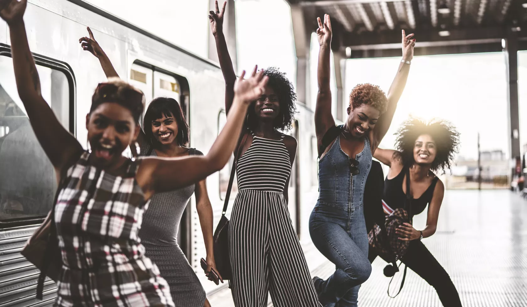 Stylish Group of Young Black Women Posing for the Camera on Subway Platform