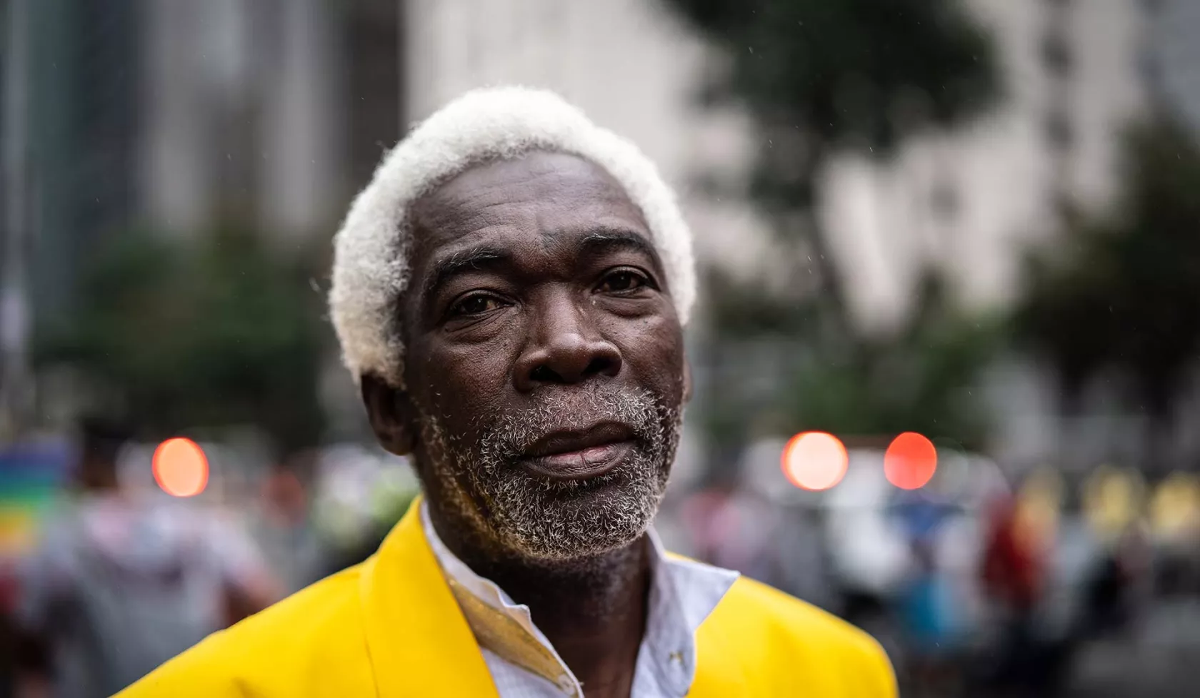 Close-up - Black Male in Front of Blurred Cityscape