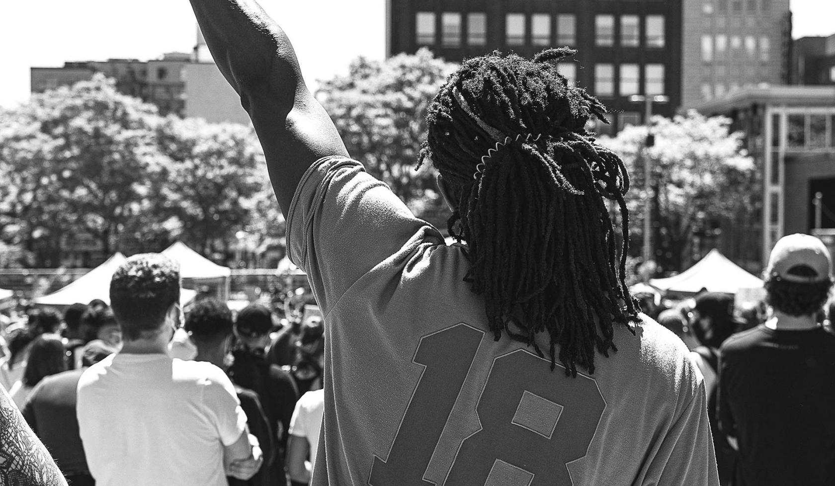 Black Male - fist raised - at protest or rally