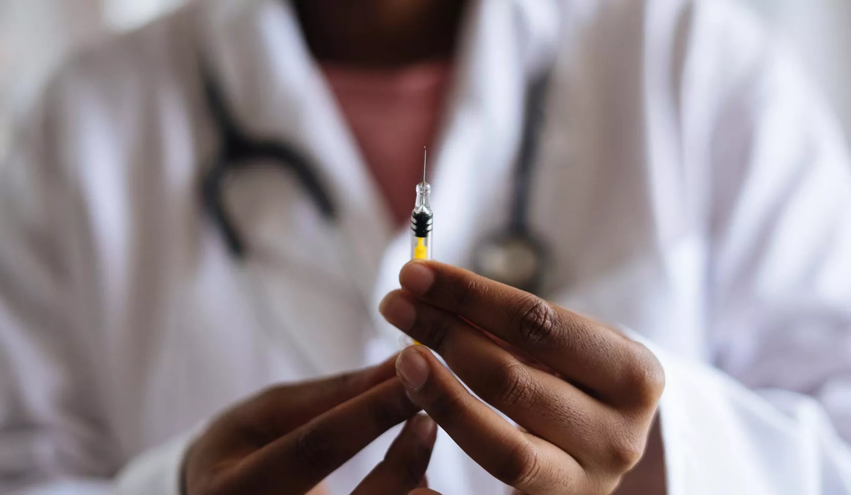 Close-up Doctor Hands holding Syringe