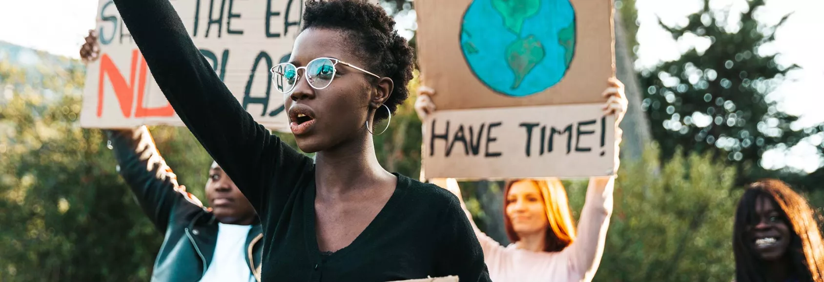 Young Adults Protesting - Holding Signs About the Environment