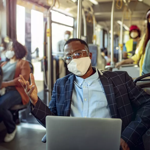 Man traveling on train with mask - COVID