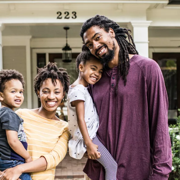 Happy Black Family outside of house